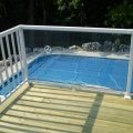 Second floor deck with glass panel barrier