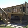 Deck with black rod railing and privacy wall (built with pressure treated lumber)