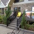 Deck and stairs with black aluminum railing, pickets and glass (built with Trex Decking)