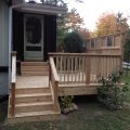 Cedar floating deck, railing and privacy wall with stained glass insterts