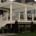 Large deck with pergola custom colour match to composite Trex railing with glass and baluster