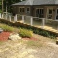 Pressure-treated deck and skirting with Regal glass railing with picket