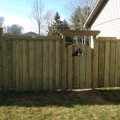 6-foot board and batten style fence with 2x6 custom top, with custom gate